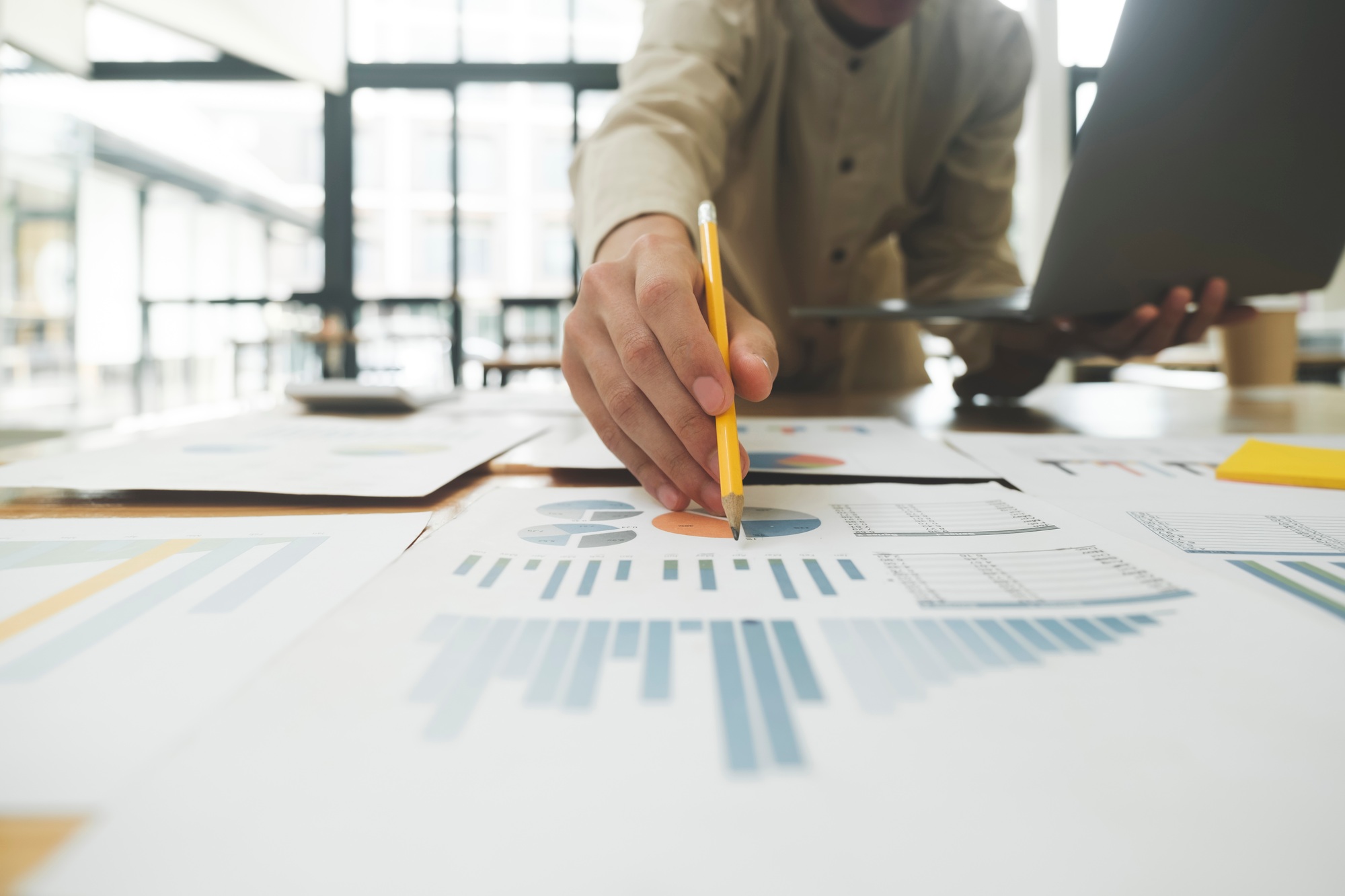 Businessman is analyzing investment project data from data report.